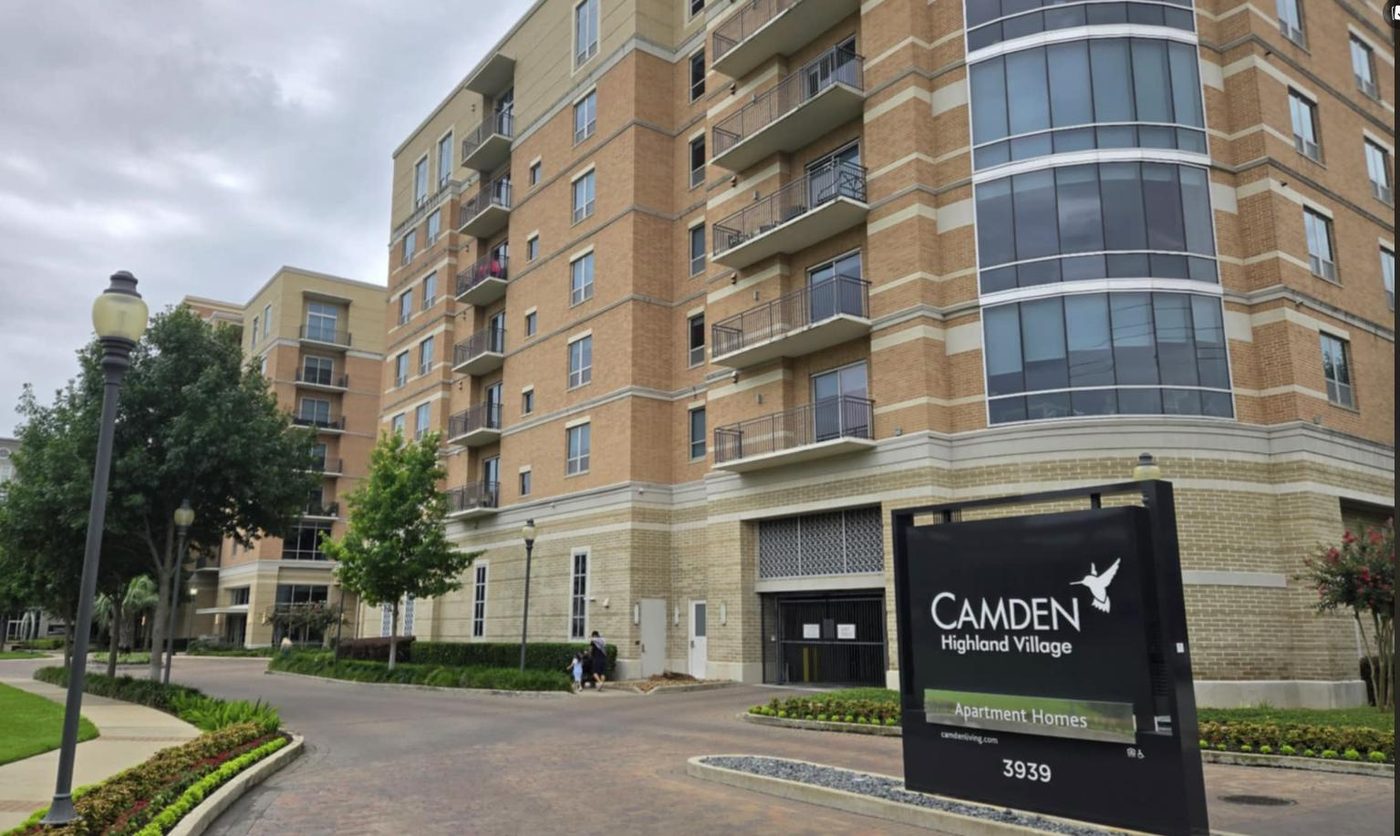 The Camden Highland Village sign in front of the brick tower on West Alabama